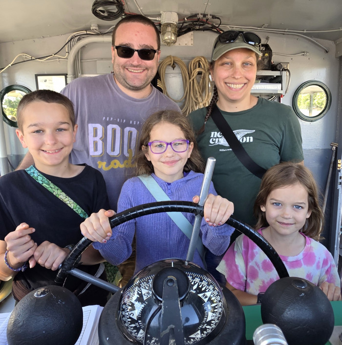 Image 4 - Family at the helm during the classic tours from the Original Soo Locks Boat Tours in Sault Ste. Marie, Michigan
