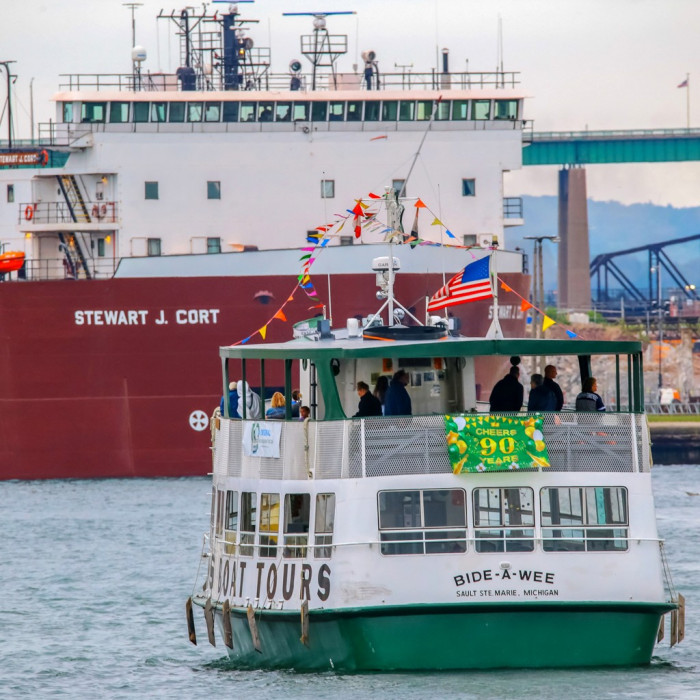 Image 1. Classic Soo Locks tour boats up close with the freighter Stewart J. Cort coming out of the Poe Lock in Sault Ste. Marie, Michigan's Upper Peninsula