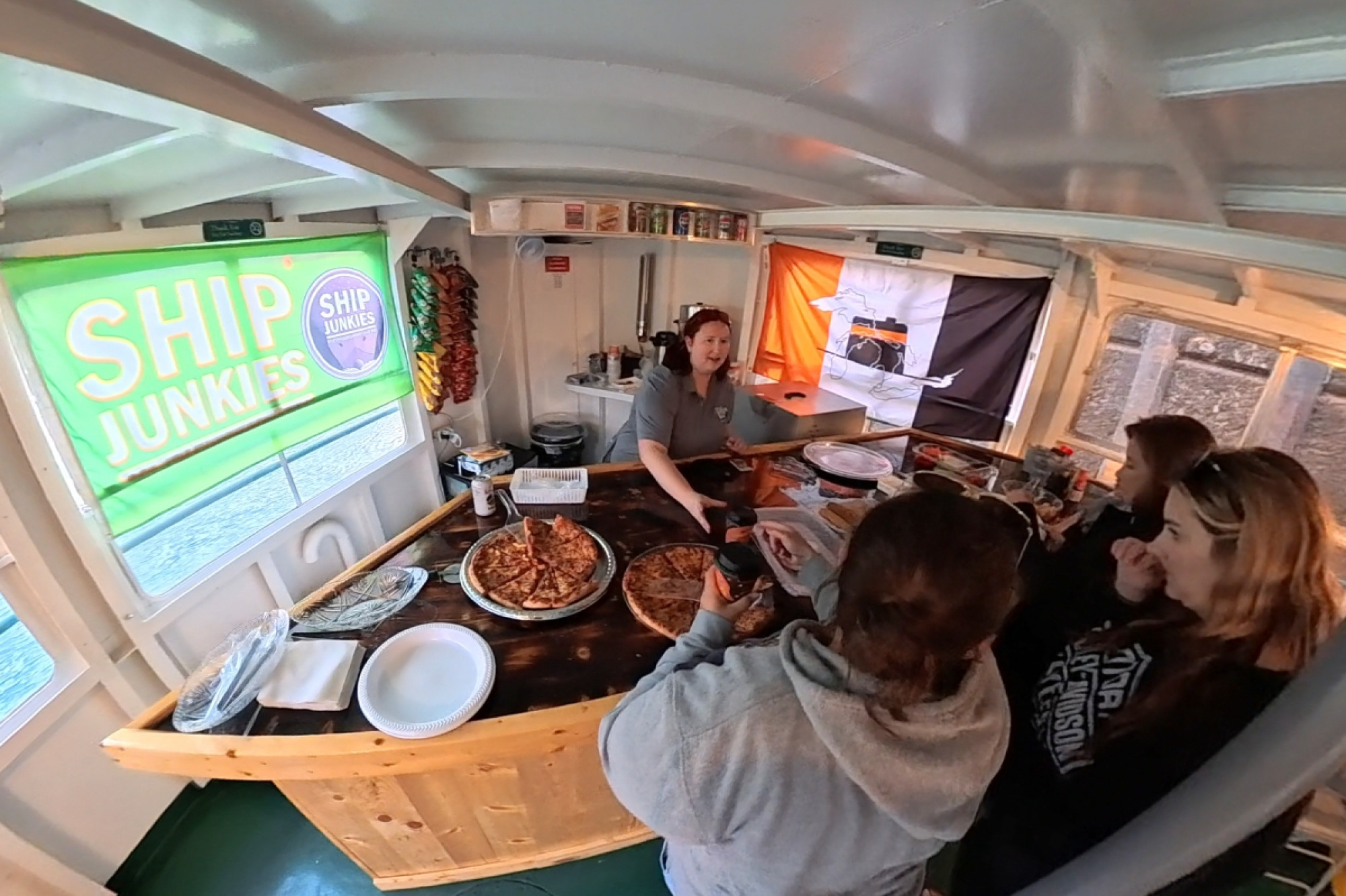 Guest being served at the bar during a themed Boatnerd Cruise with Original Soo Locks Boat Tours in Sault Ste. Marie, Michigan, sponsored by Interlake Steamship Company and Domino’s Pizza
