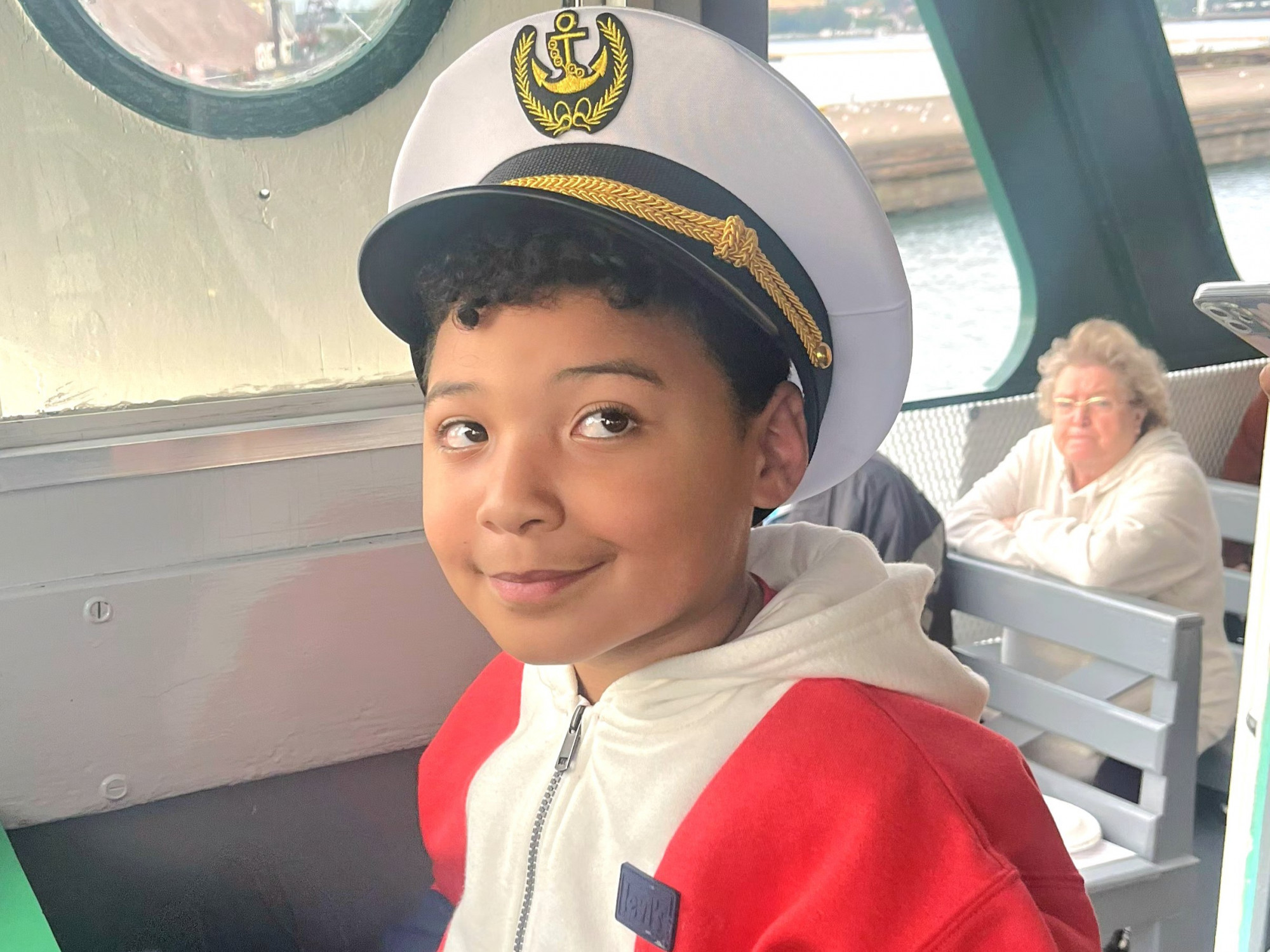 Young guest Mason riding in the Pilot House during an Original Soo Locks family‑themed Boatnerd Cruise in Sault Ste. Marie, Michigan