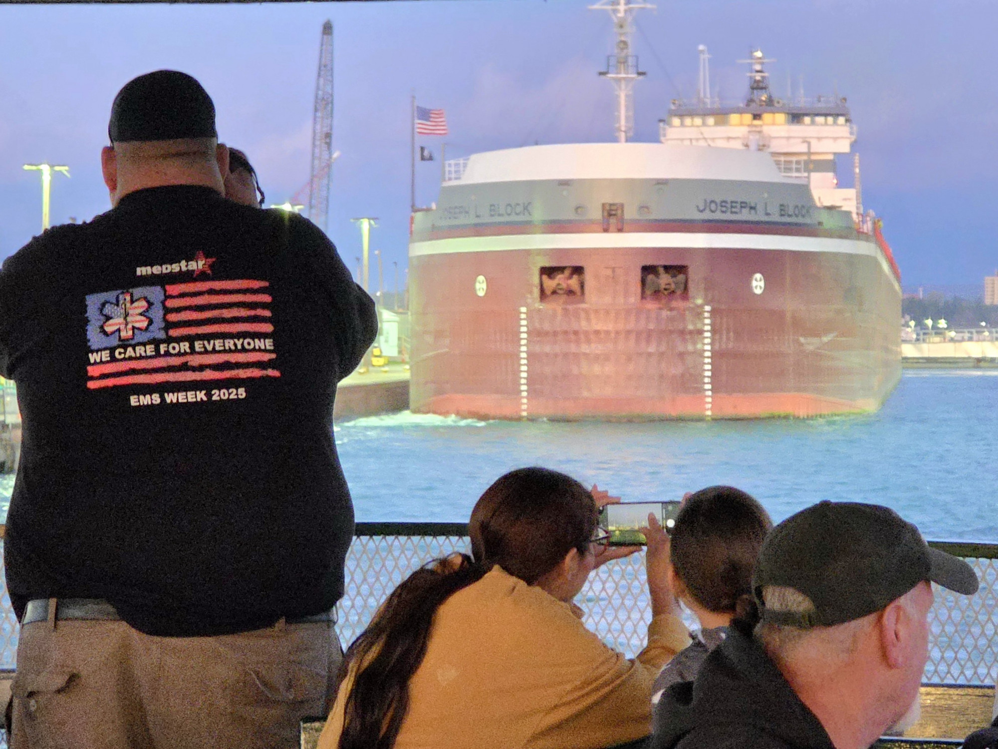Guest taking photos while watching the Great Lakes freighter Joseph L. Block during the Original Soo Locks Boatnerd and Ship Junkies themed family cruise in Sault Ste. Marie, Michigan
