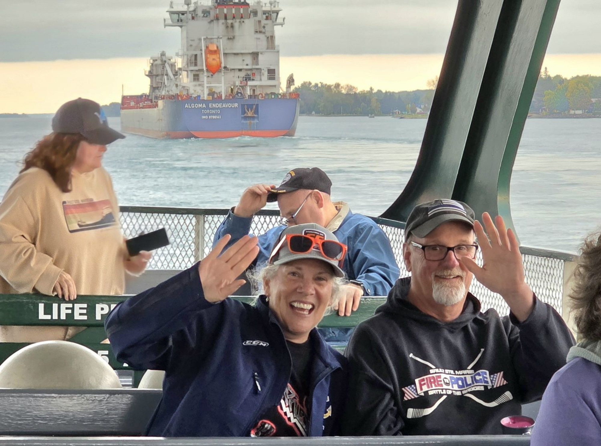 Boatnerd guest smiling and having fun onboard the Original Soo Locks Boatnerd Cruises during a family‑friendly event in Michigan’s Upper Peninsula