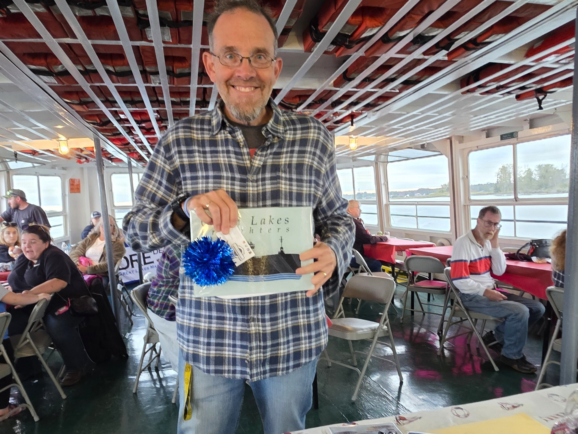 Guests celebrating and receiving prizes during a family‑friendly Boatnerd Sunset Cruise with Original Soo Locks Boat Tours in Sault Ste. Marie, Michigan