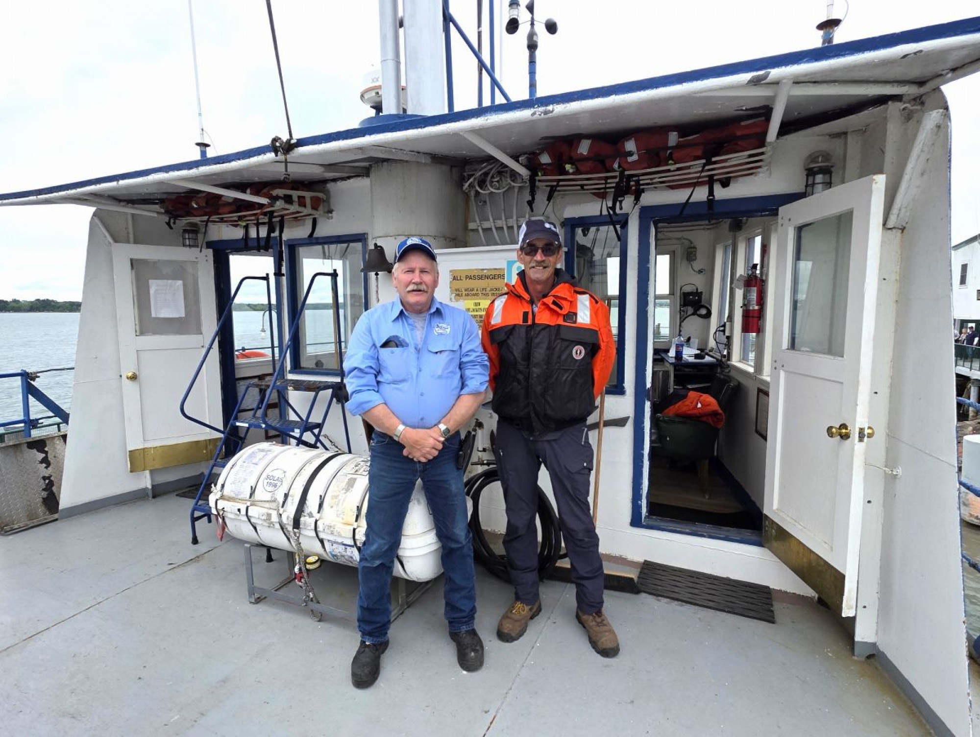 The crew of the Soo Marine Supply Boat Ojibway docked at the Original Soo Locks Boat Tours during the maritime event Little Sailors Day Kids Ride Free her in Sault Michigan.