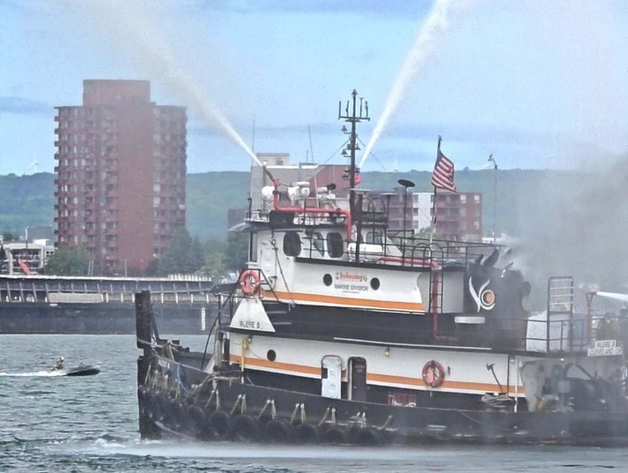 The tugboat Shirley Ann from Kokosing putting on a water display for Little Sailors Day at the Original Soo Locks Boat Tours dock Sault Ste. Marie family maritime event in Michigan's Upper Peninsula