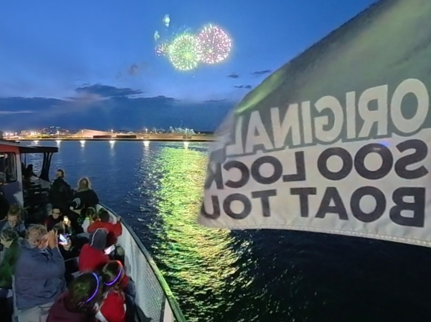 Locking out from the deck of the Original Soo Locks Tour Boat the Holiday with stunning fireworks in the foreground here in Sault Ste. Marie, Michigan.