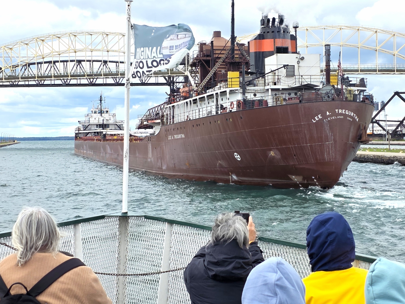 A freighter view of Interlake Steamship Company's Lee A. Tregurtha from of the Original Soo Locks Tour Boat the Holiday with the International Bridge in the background here in Sault Ste. Marie, Michigan