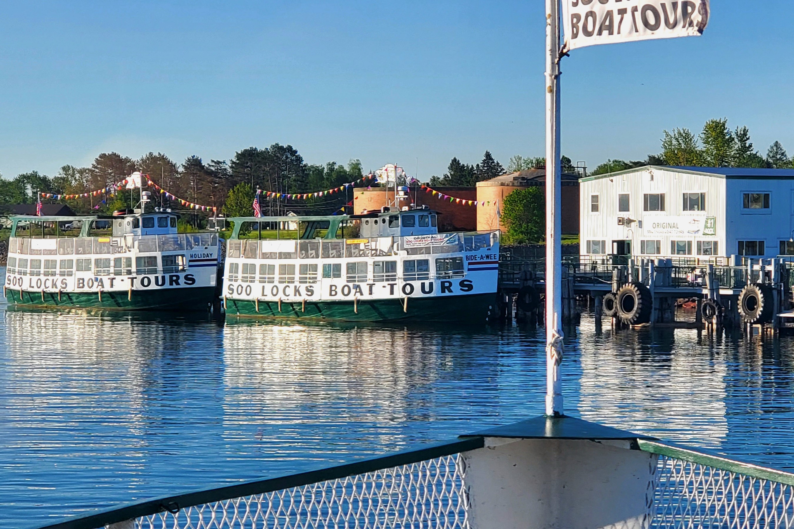 View of the Original Soo Locks Boat Tours vessels and dock from the water.