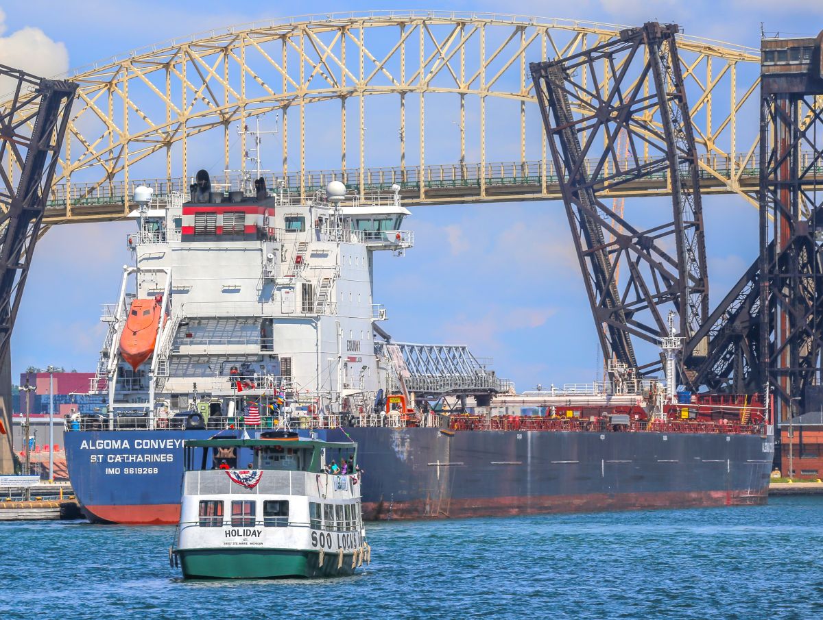 Freighter Algoma Conveyor near the Holiday tour boat by the International Bridge