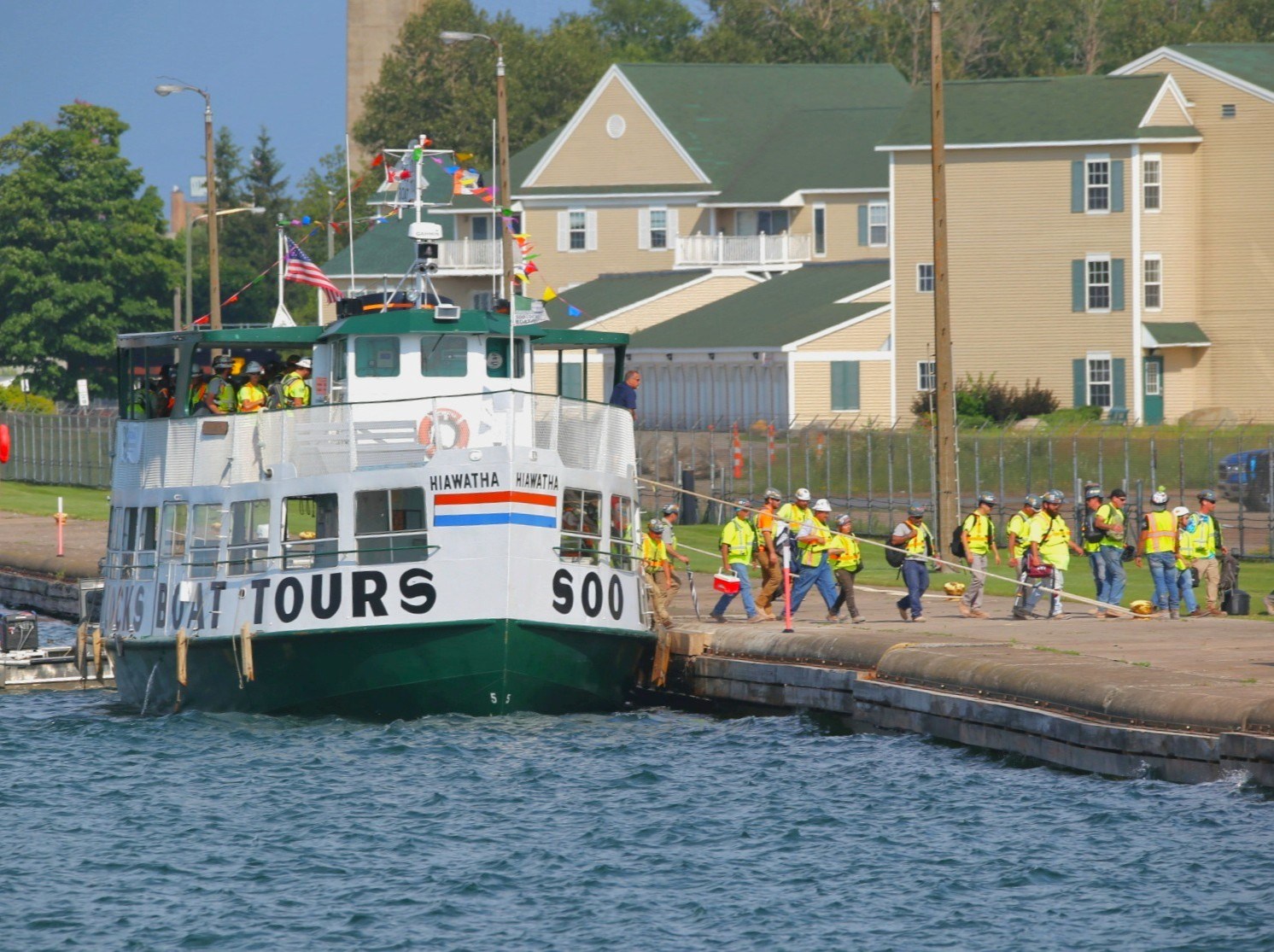 Construction workers departing the Original Soo Locks tour boat Hiawatha for the new lock project in Sault Michigan