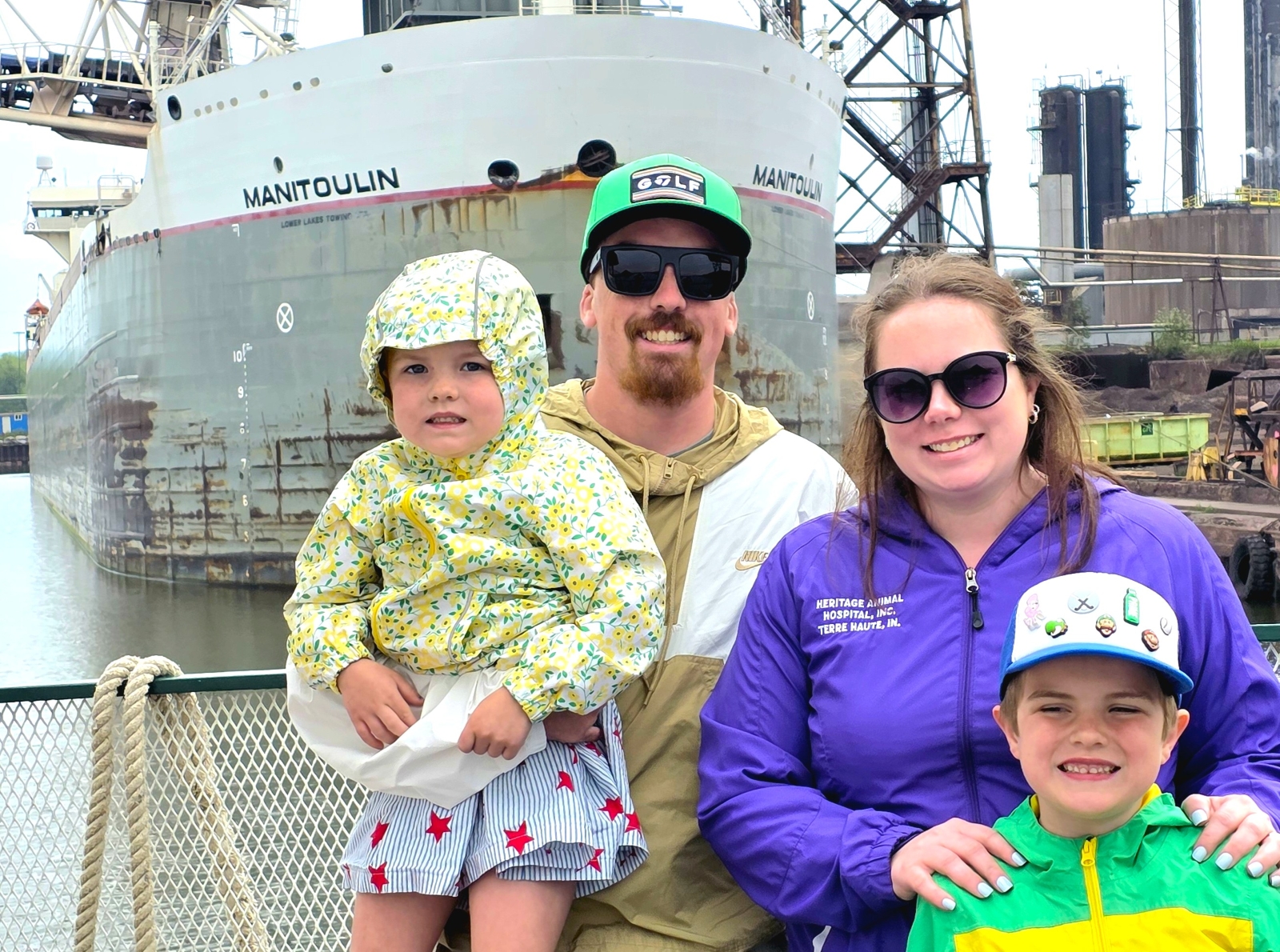 Family onboard the Soo Locks tour boat with a up close view of the Great Lake Freighter Manitoulin with the Original Soo Locks Boat Tours in Michigan's Upper Peninsula