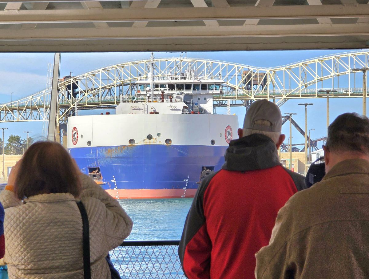 Guests watching a Great Lakes freighter during a Soo Locks boat tour